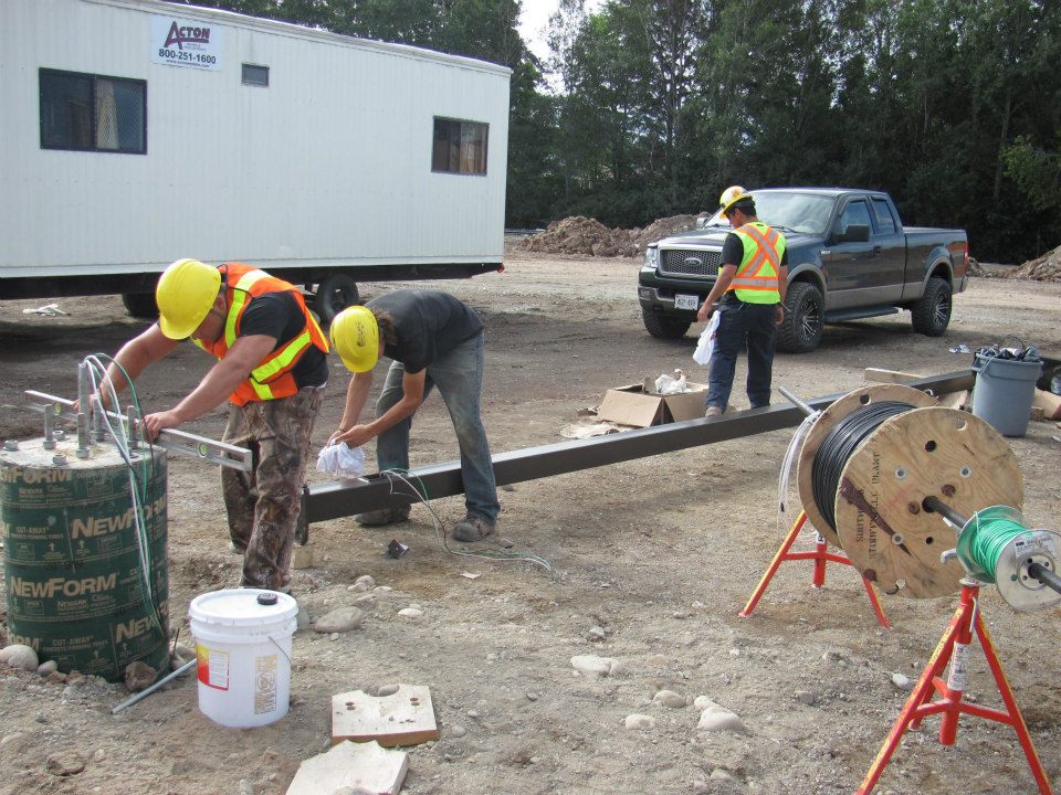 Topline Electric crew laying conduit at a job site