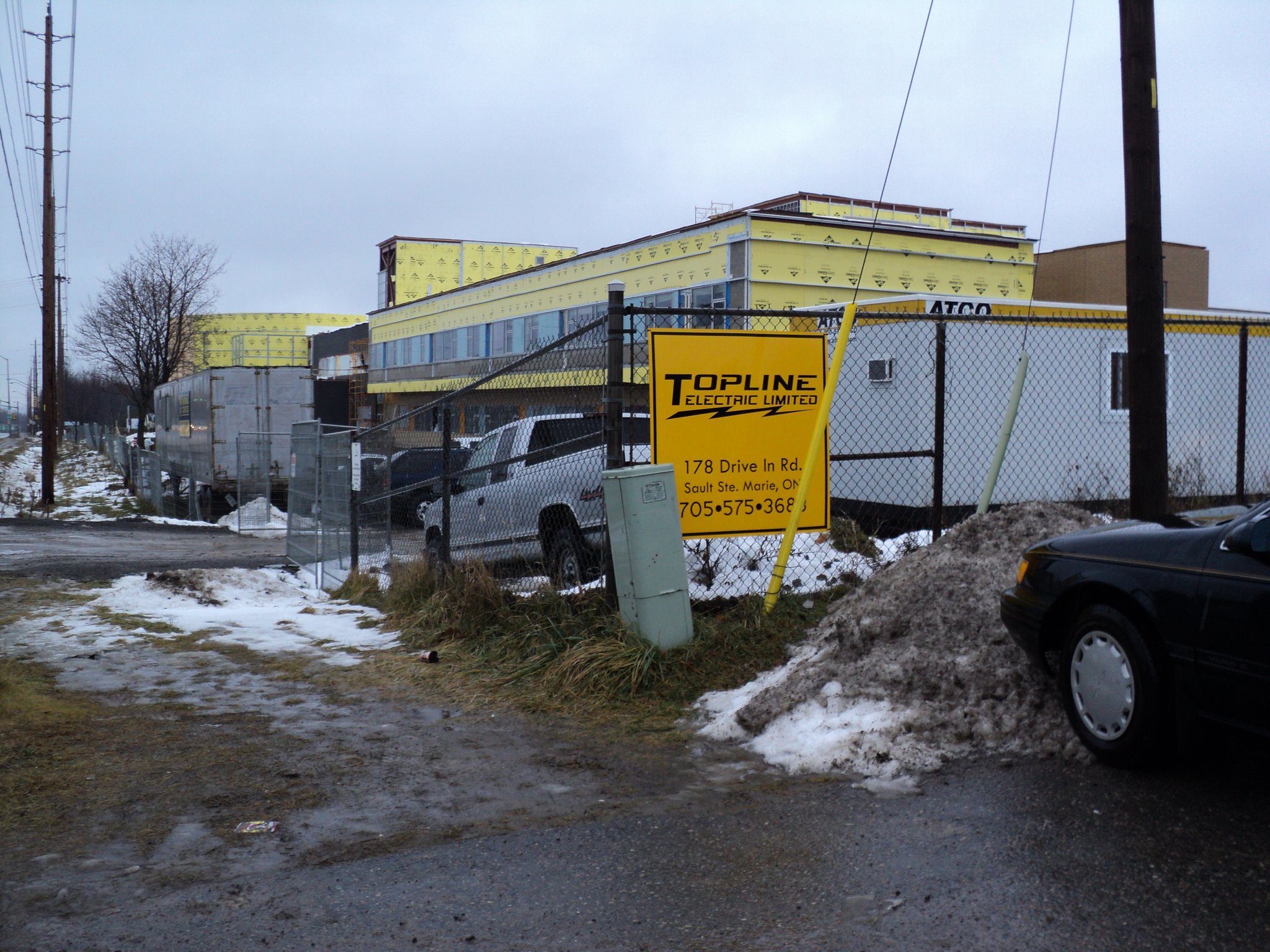 Topline Electric Limited job site with company signage